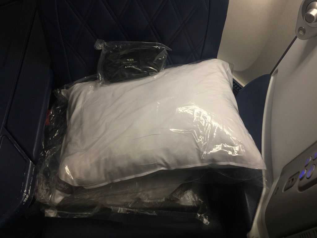 Delta Air Lines Fleet Boeing 777-200ER Business Elite Class (DELTA ONE) seat was already decked out with slippers, amenity kit, and Delta’s excellent bedding and pillows kit