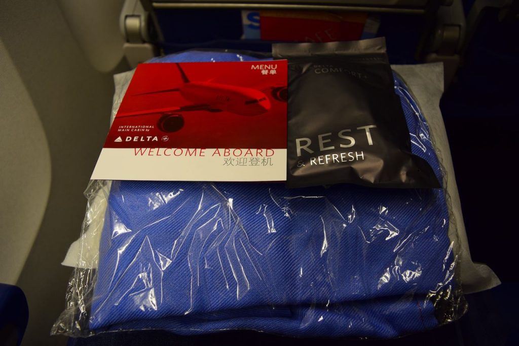 Delta Air Lines Fleet Boeing 777-200ER Premium Economy (Comfort+) Pre-placed on the seat were pillow, blanket, menu, and comfort kit