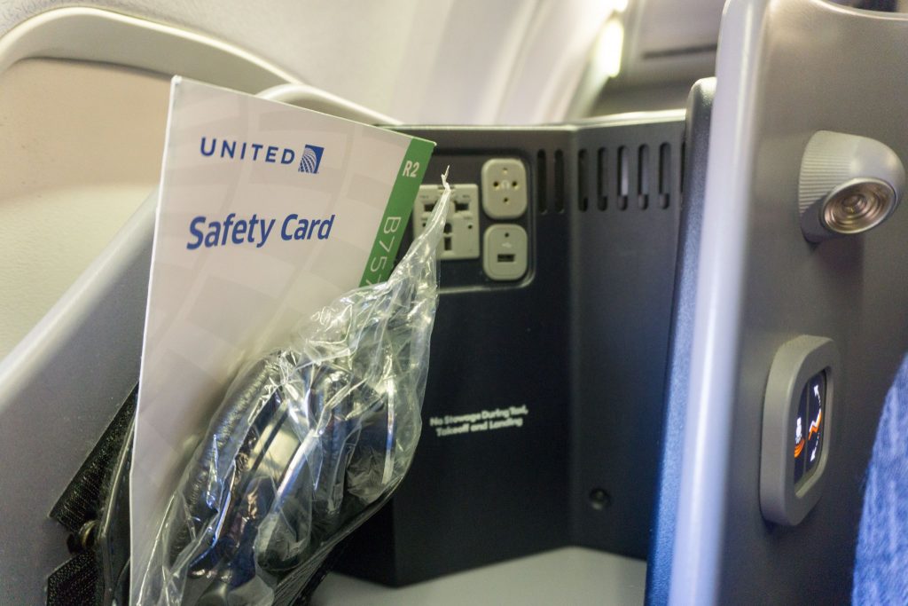 United Airlines Aircraft Fleet Boeing 757-200 Polaris Business:First Class Cabin seats small area at the upper corner of the seat where headphones, charging ports and an additional light were