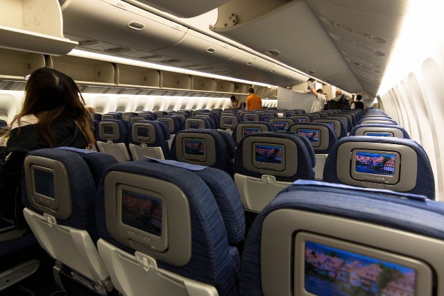 United Airlines Fleet Widebody Aircraft Boeing 777 200 Economy Class cabin long haul flight passenger boarding photos