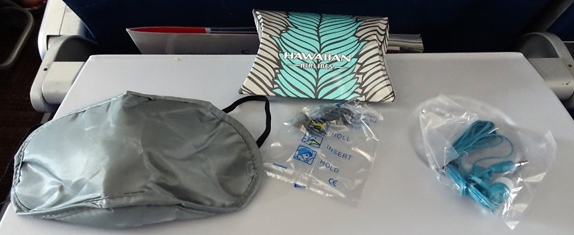 Airbus A330 200 Hawaiian Airlines Economy Class Cabin small amenity pouch containing a sleep mask earplugs and earphones 1