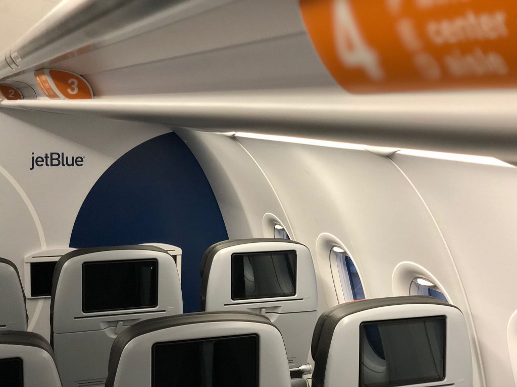 JetBlue Airways Airbus A320 200 Restyled Interior Cabin New branded partitions and orange placards demarcating Even More Space seating