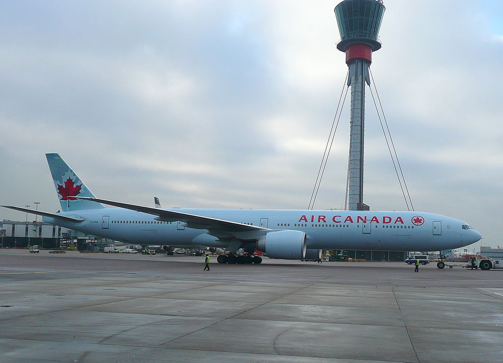Boeing 777 300ER of Air Canada C FIUL pushing back off std 335 in front of the new control tower at LHR