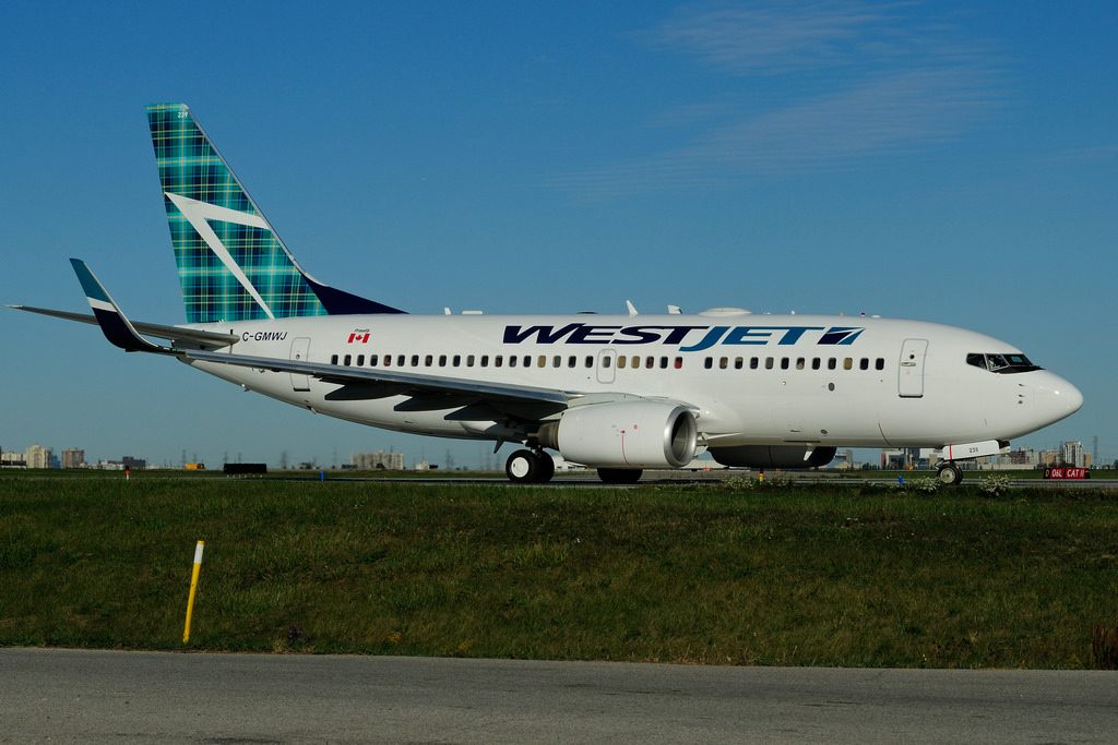 C GMWJ Boeing B 737 7CTW WestJet Tartan tail livery at Toronto Lester B. Pearson Airport YYZ