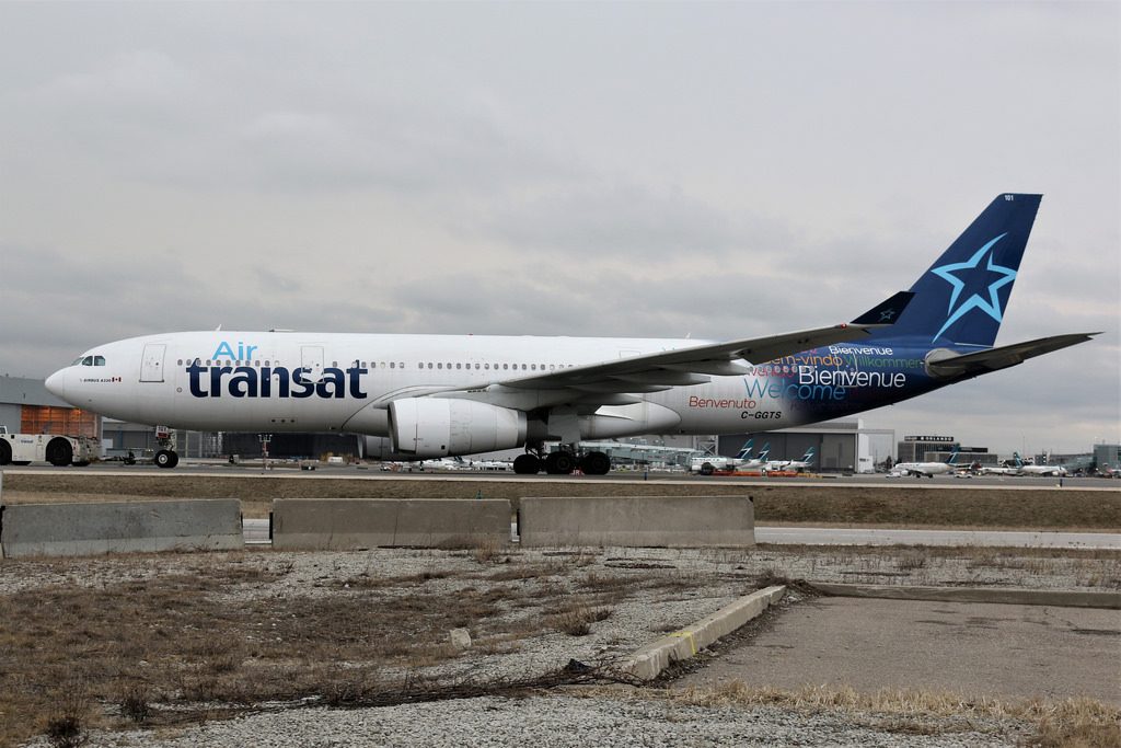 Air Transat C GGTS Airbus A330 243 Plane being towed to infield terminal to be parked YYZ CYYZ Toronto Pearson Airport