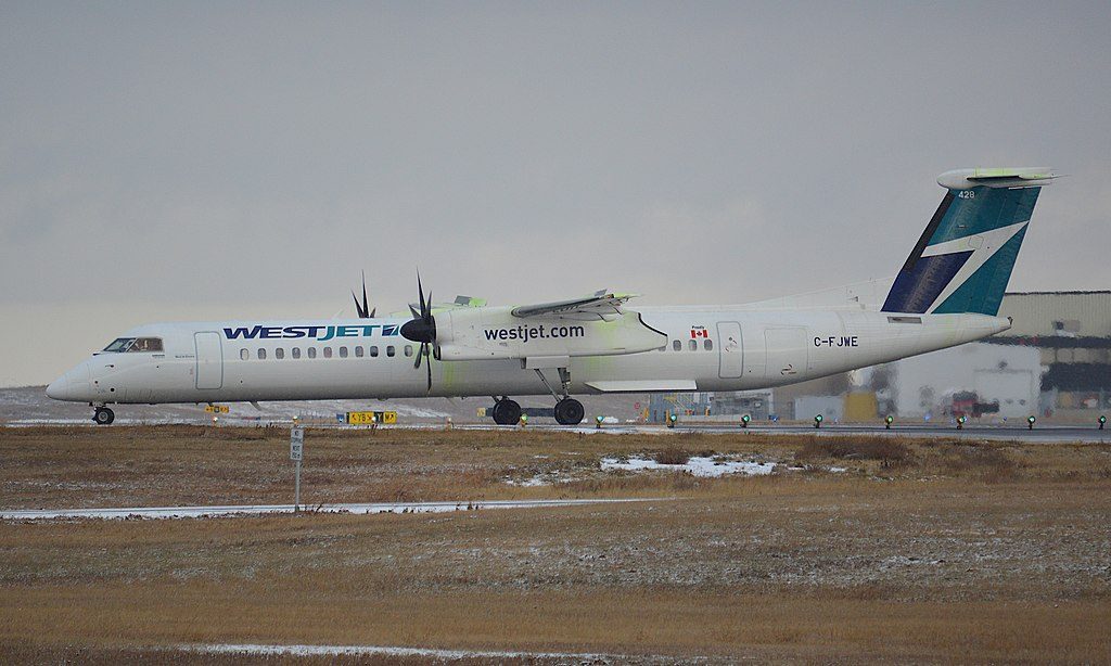 WestJet Encore Dash8 Q400 C FJWE taxiing for takeoff at Calgary International Airport